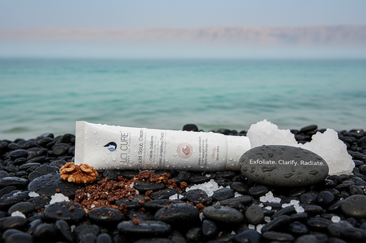 La Cure Facial Scrub Cream 100ml with Dead Sea minerals and walnut shell granules on black Dead Sea pebbles for skin exfoliation and pore cleansing