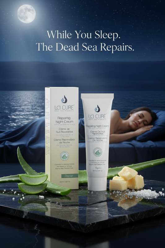La Cure Repairing Night Cream tube and box with aloe vera and Dead Sea salt crystals under moonlight beside the Dead Sea for overnight skin repair and firming
